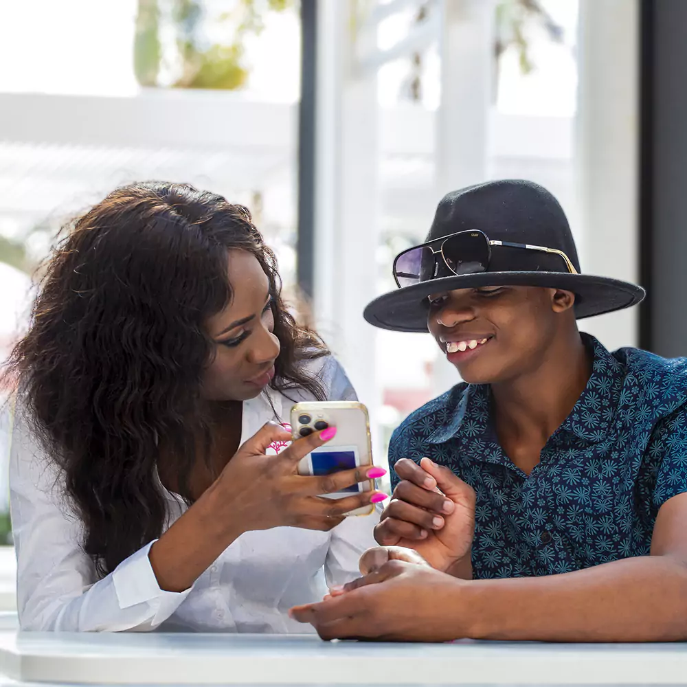 Jinga's founder showing something on her phone to one of her participants